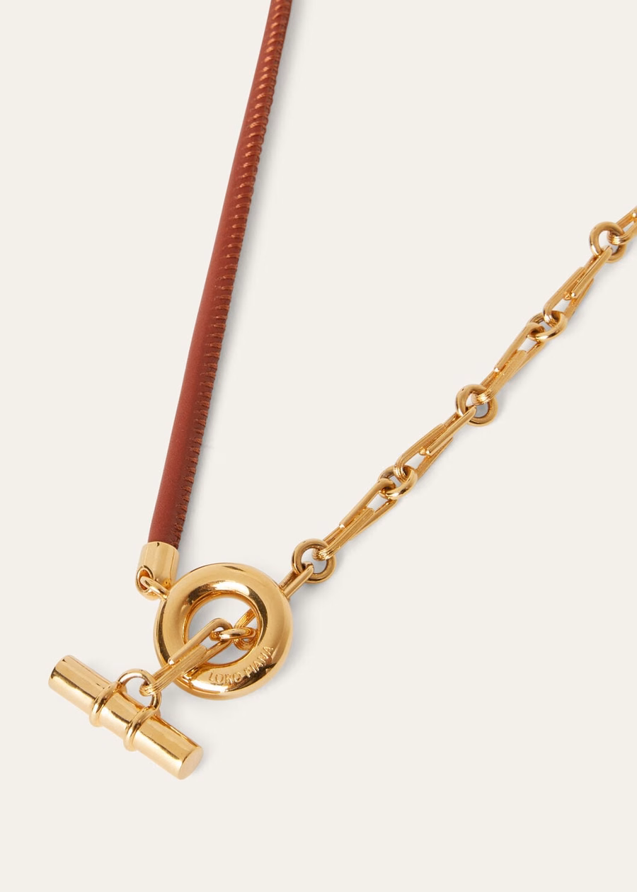 Klauwketting van messing met zonmotief in goud/diep kummel-patroon